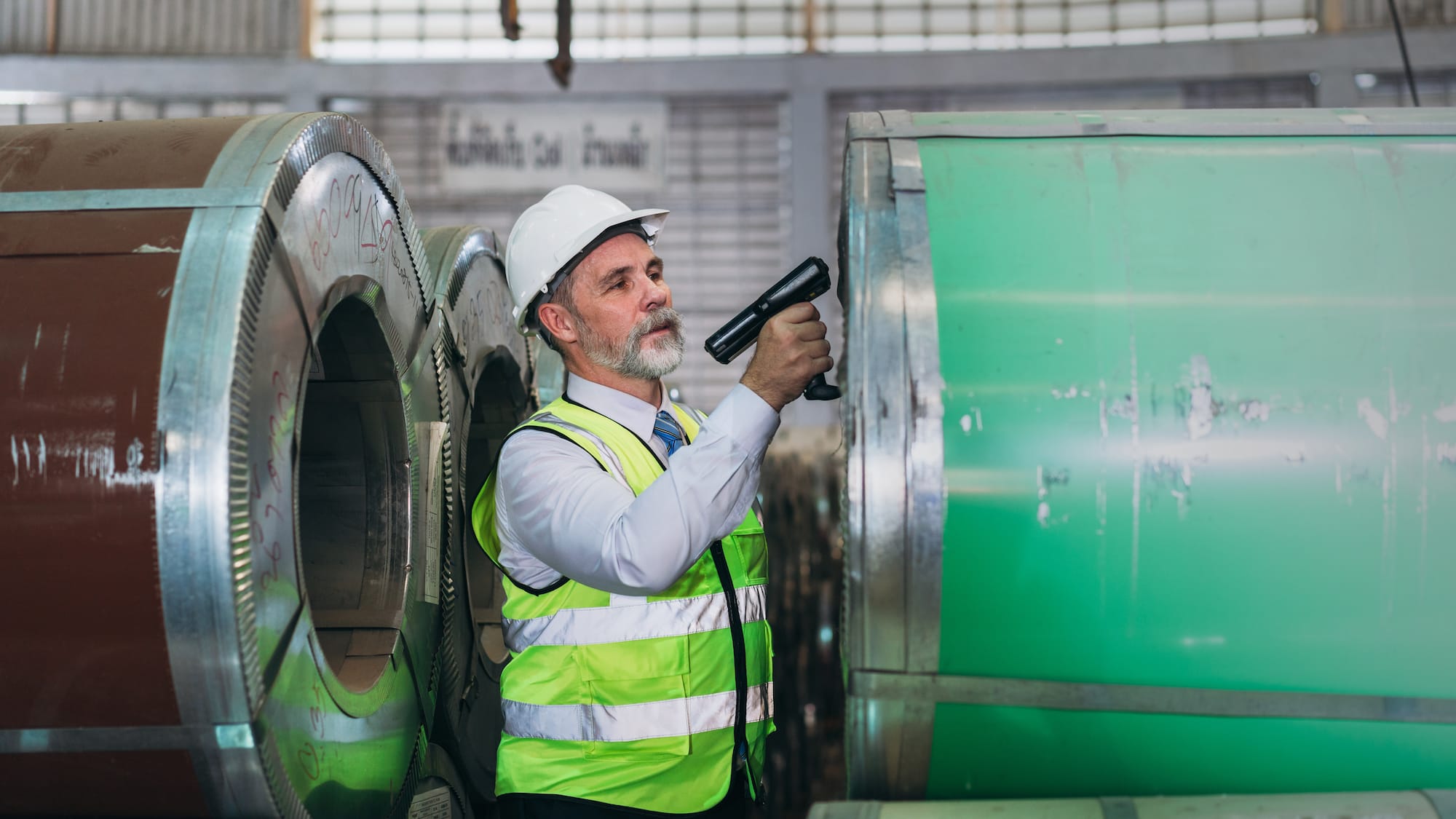 Man using infrared scanning on machine in factory