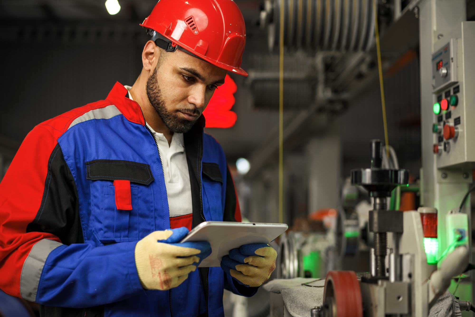 African american male manager in electric cable warehouse holding digital tablet, close up