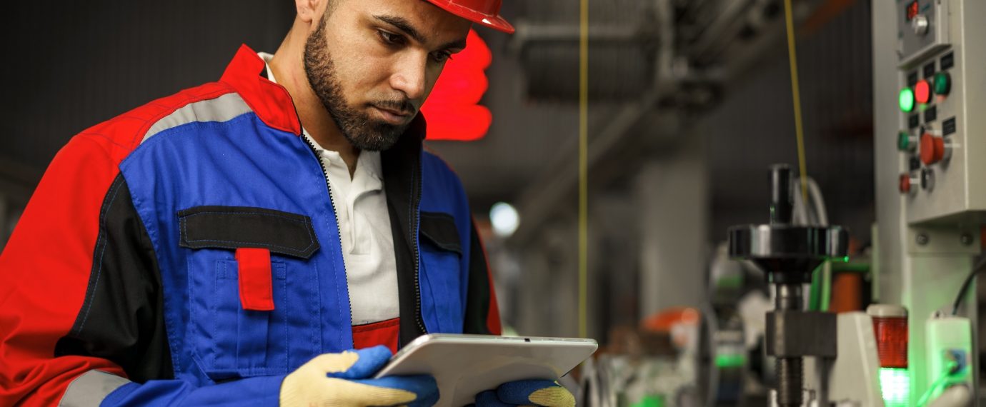 African american male manager in electric cable warehouse holding digital tablet, close up