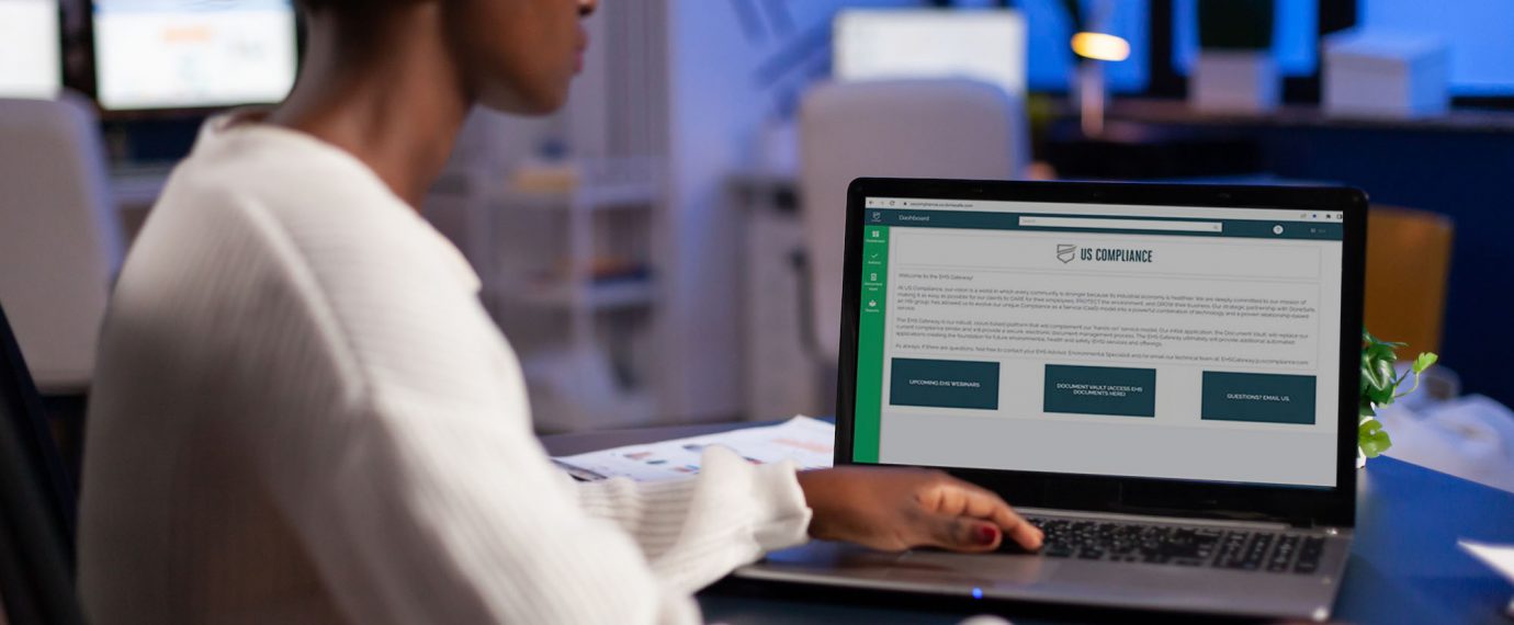 A woman sitting with a laptop showing the EHS Gateway