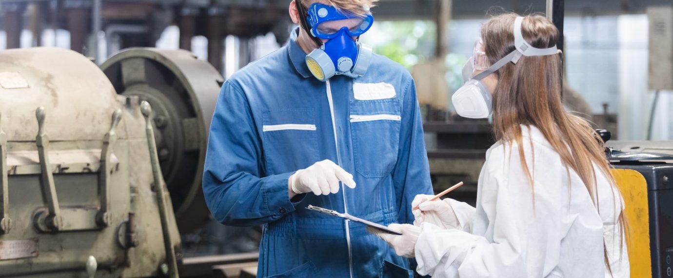 Two factory workers wearing respiratory protection