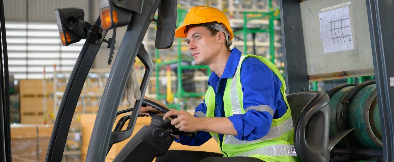 Worker in auto parts warehouse using a forklift